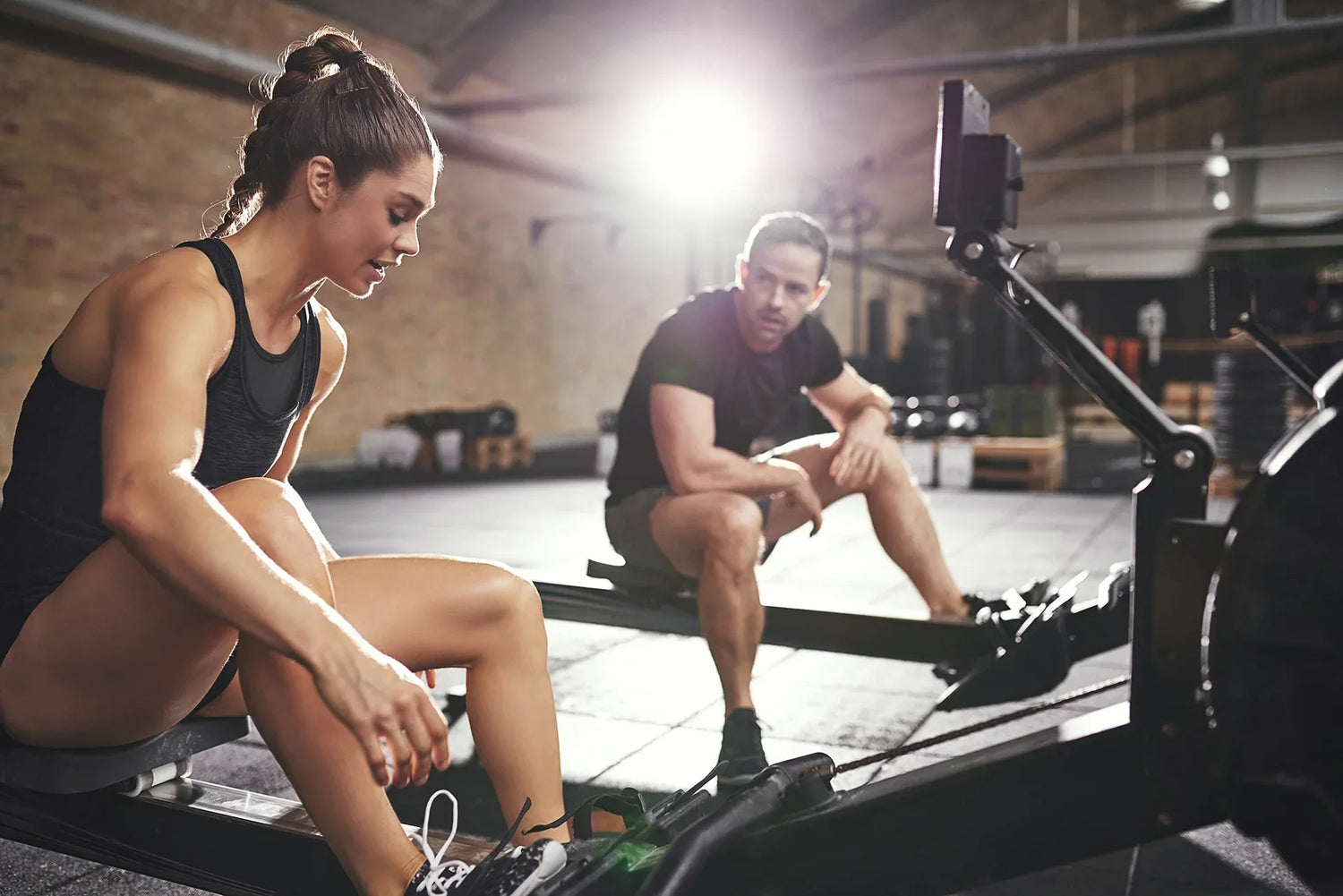 Athletes on the Rowing Machine at Gym