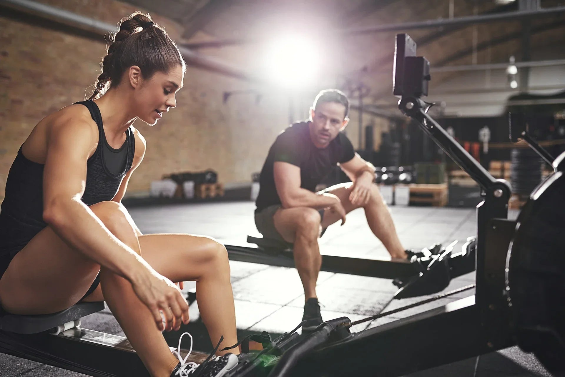 Athletes on the Rowing Machine at Gym