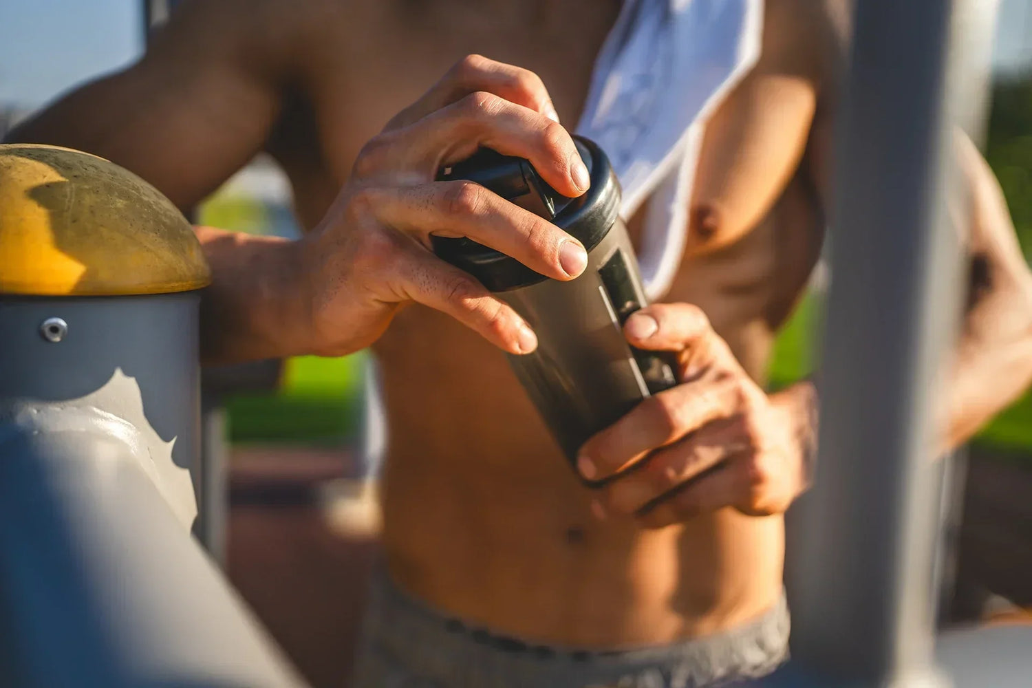 Athletic Male Holding Protein Shaker