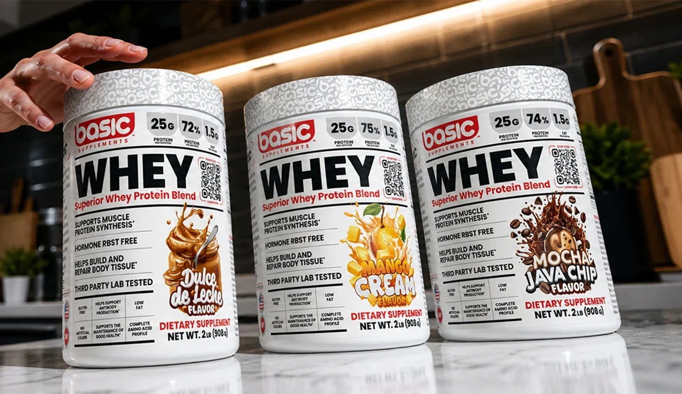 Hand reaching for a tub out of a line up of Basic Whey Flavours