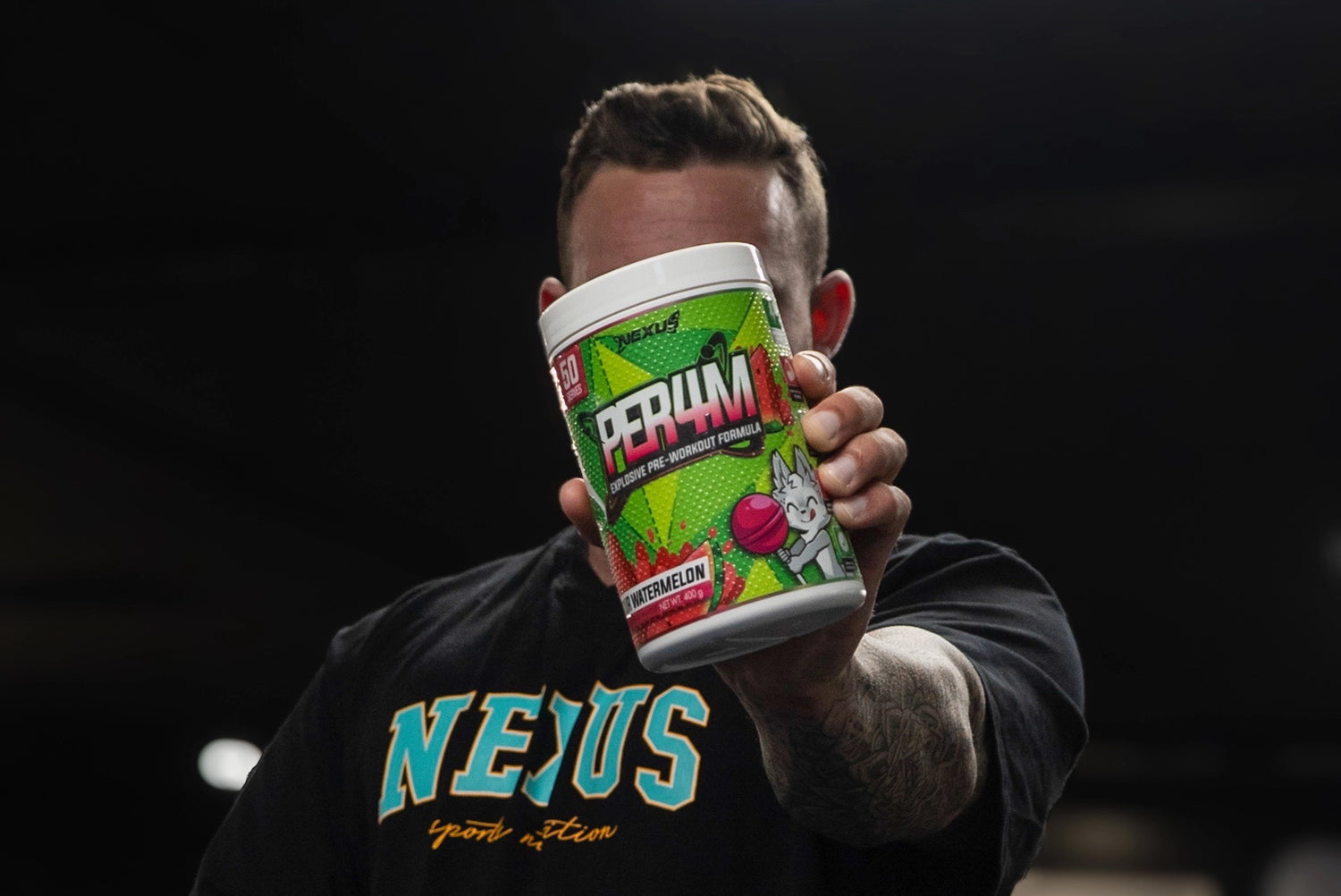 Guy holding Nexus PER4M Pre-Workout Sour Watermelon
