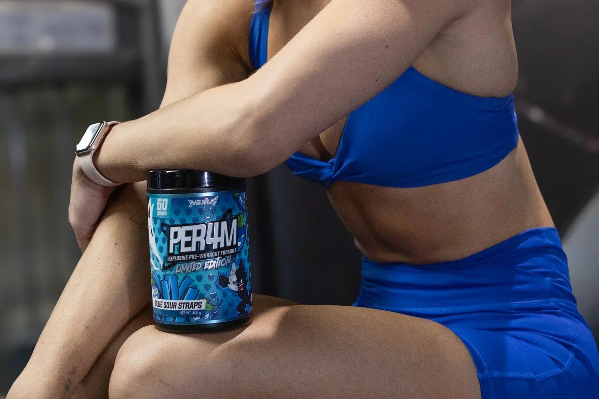 Woman Holding Nexus PER4M Pre-Workout