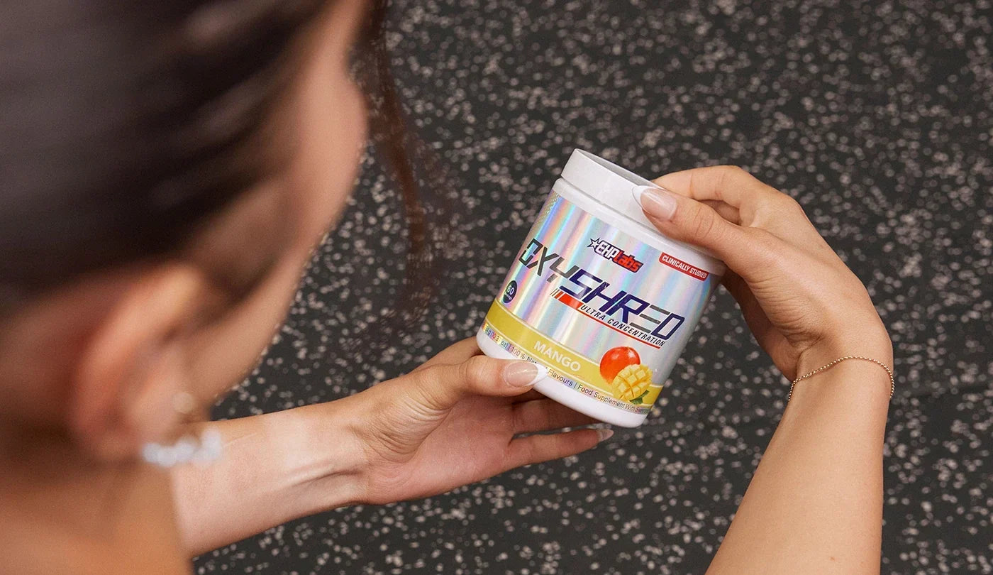 EHP Athlete holding a tub of OxyShred Mango
