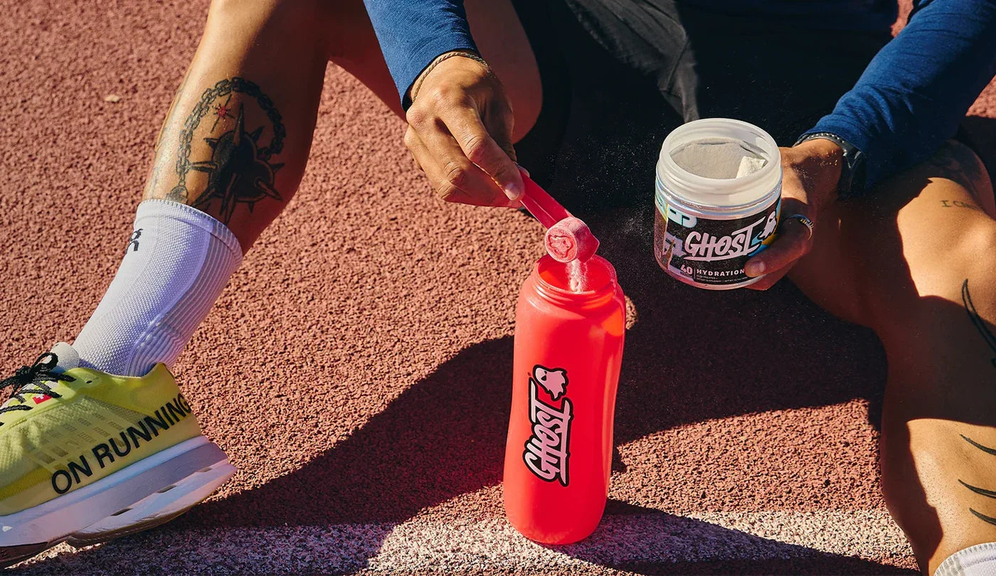 Athlete scooping Ghost Hydration in to a bottle