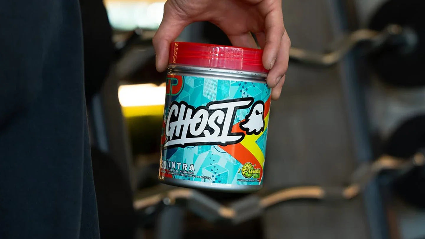 Person holding a tub of Ghost Intra Lemon Lime