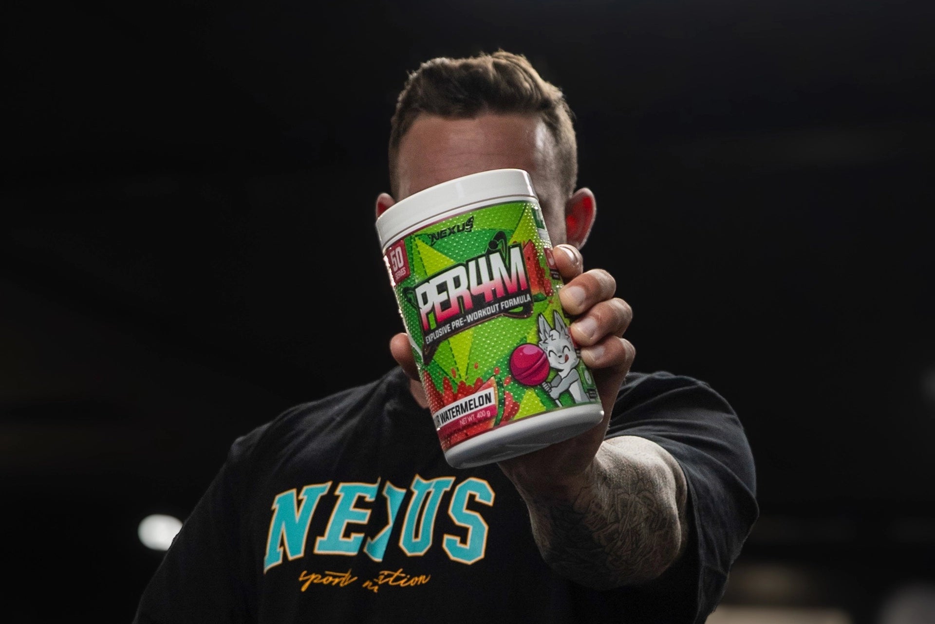 Guy holding Nexus PER4M Pre-Workout Sour Watermelon