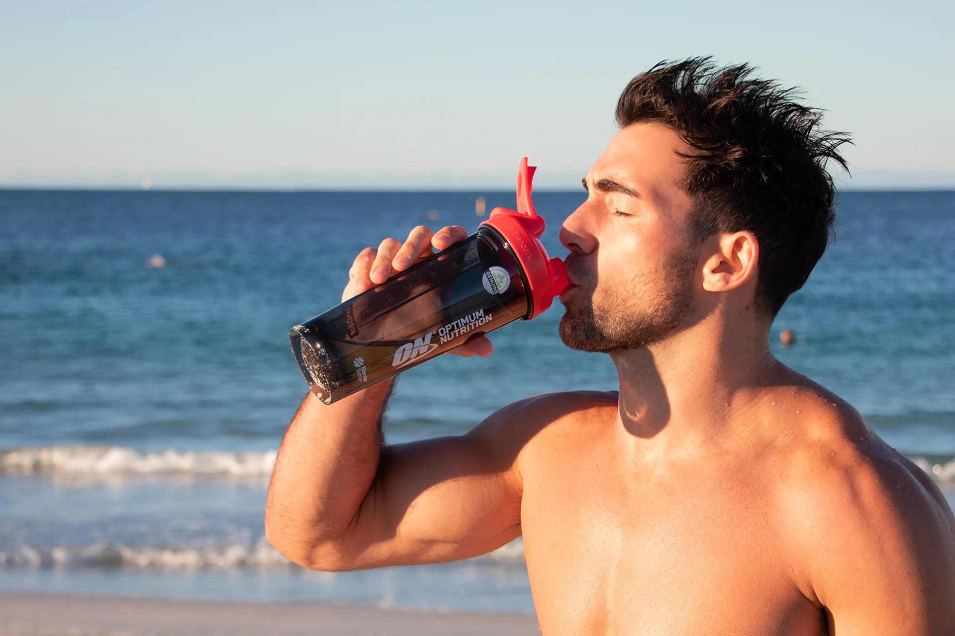 Optimum Nutrition Athlete - Sipping from shaker at the beach.