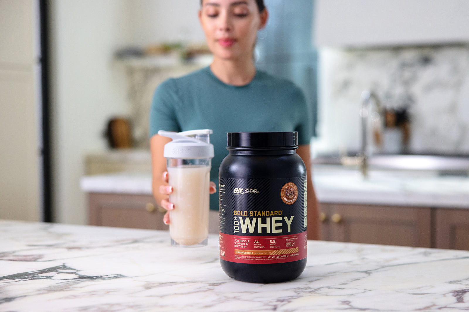 Woman Drinking Optimum Nutrition Gold Standard Whey - Cinnamon Roll