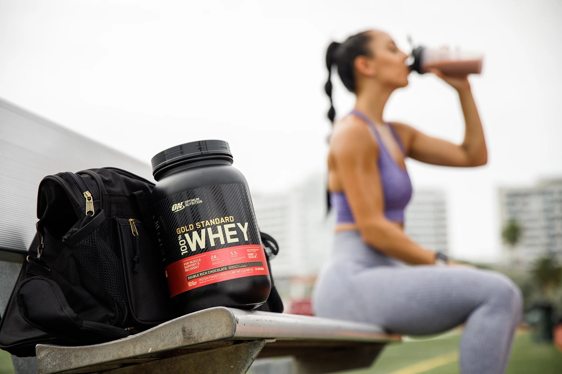 Woman Drinking Gold Standard Whey