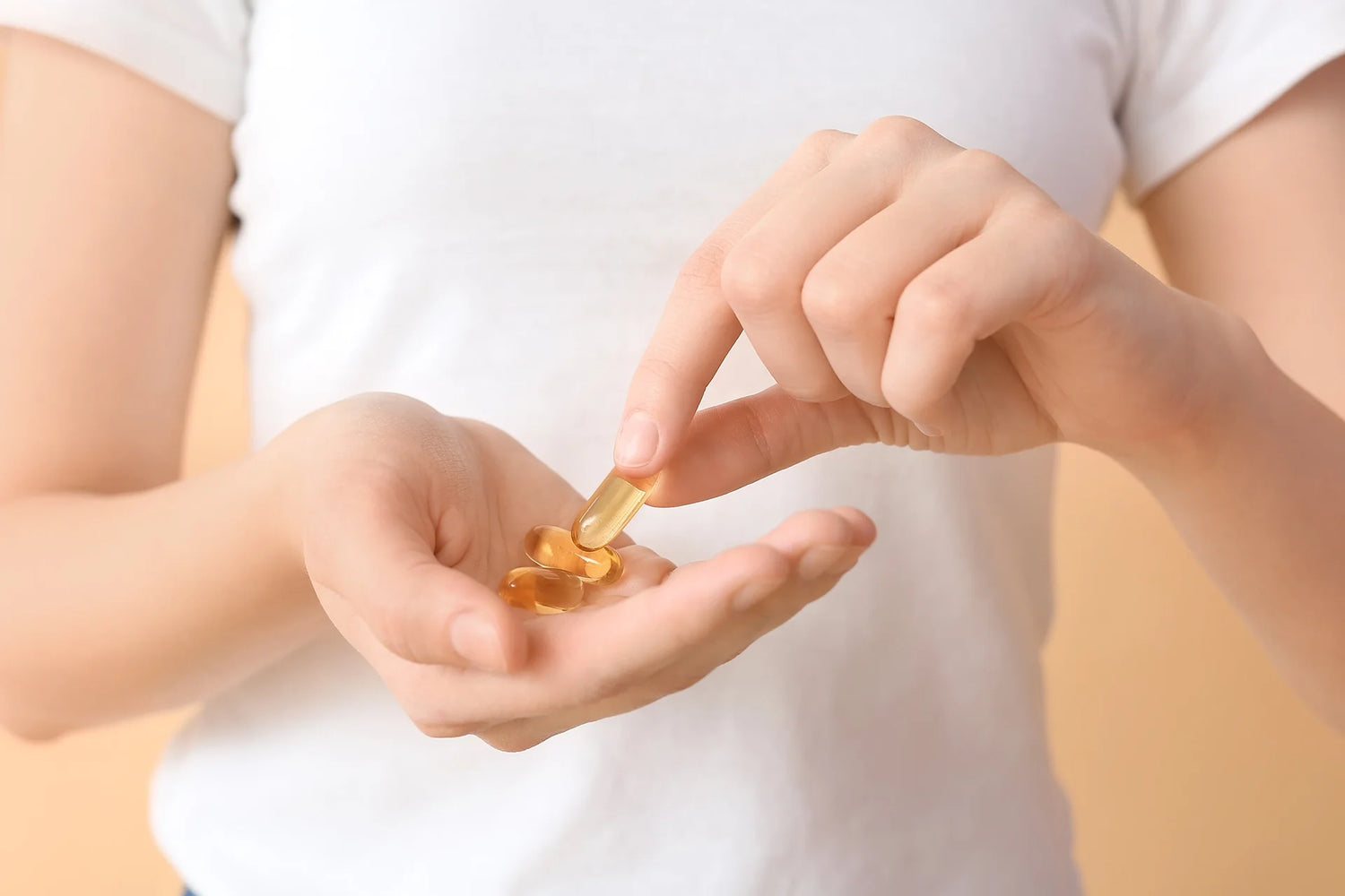 Woman Holding Fish Oil Capsules