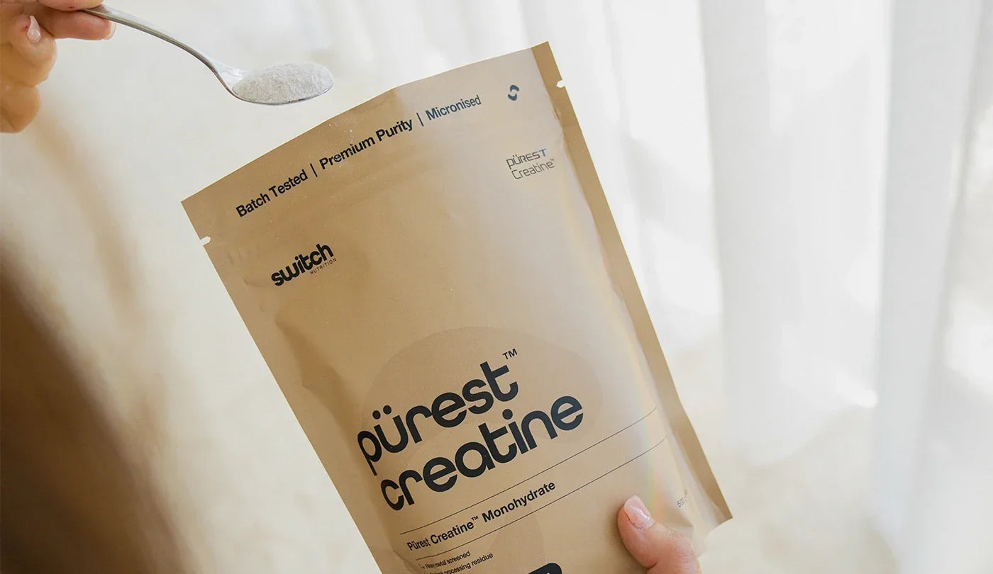 Person getting a scoop of Switch Nutrition Purest Creatine Monohydrate