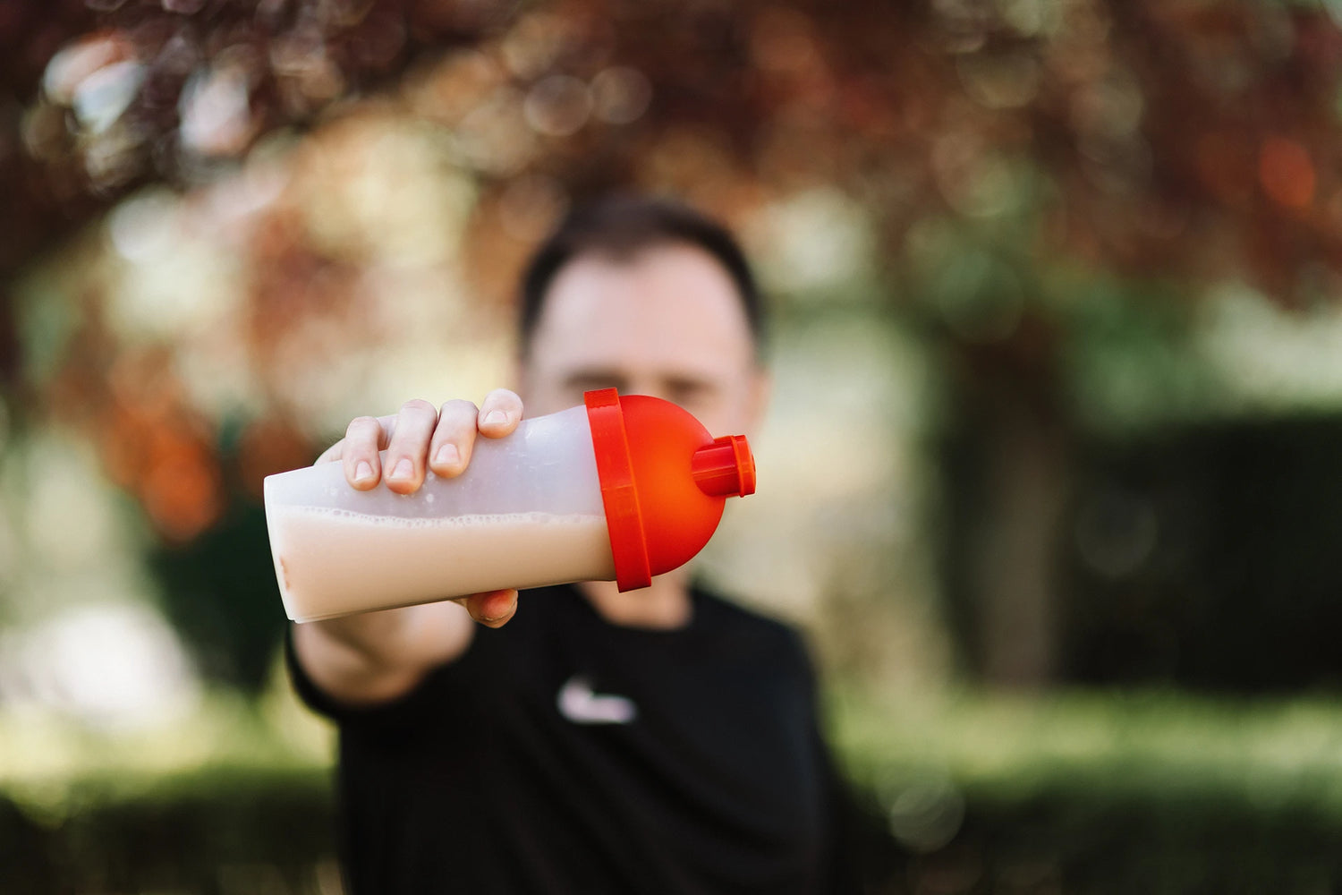 Guy holding protein shake 