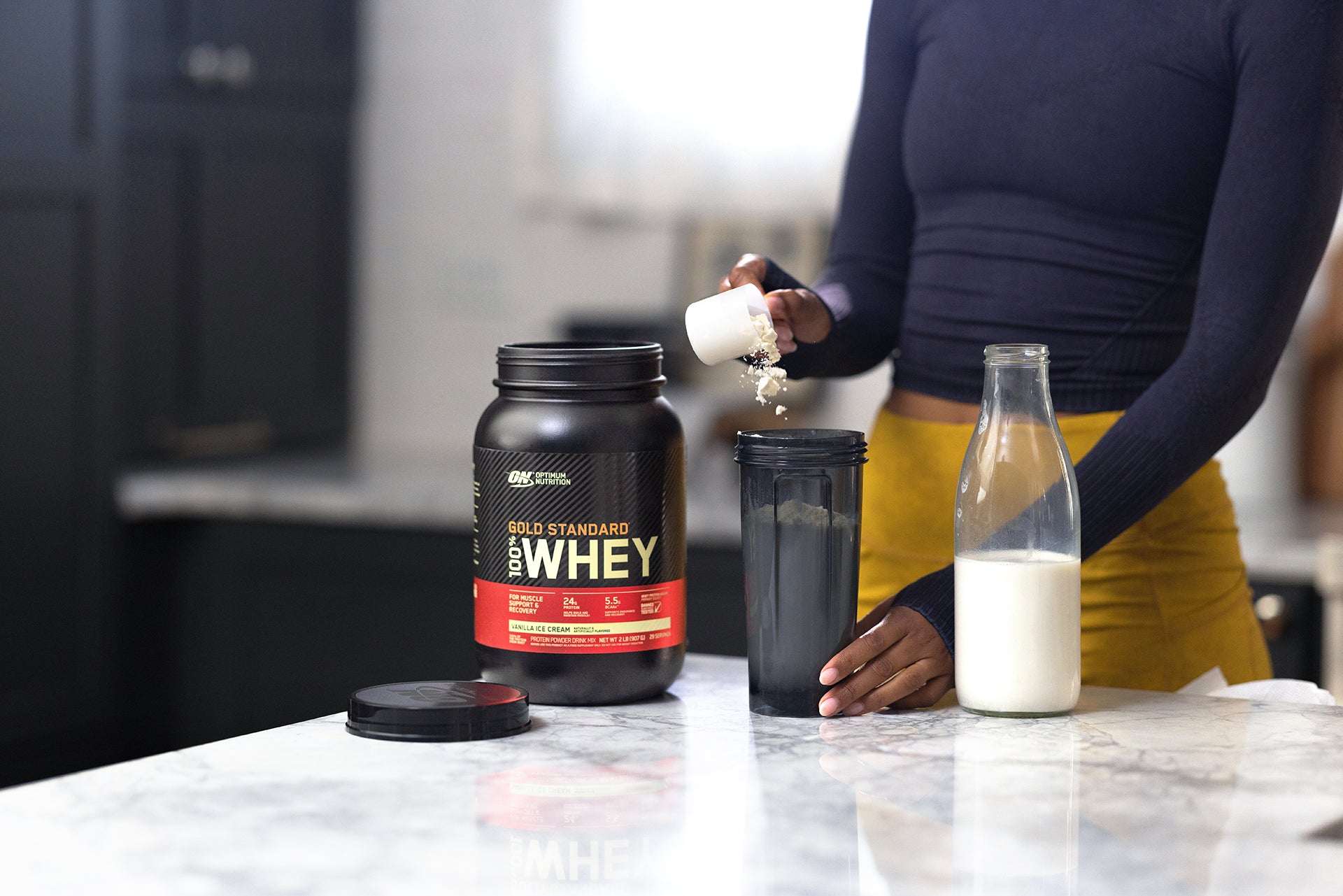 Woman making a protein shake - Gold standard whey